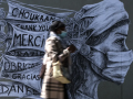 Une femme portant un masque devant une œuvre du street artiste Ardif à Paris, 15/05/2020. © OEL SAGET / AFP 