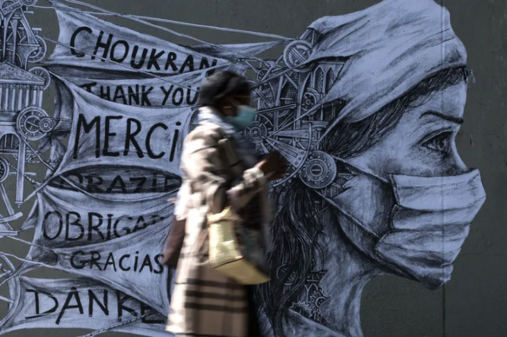Une femme portant un masque devant une œuvre du street artiste Ardif à Paris, 15/05/2020. © OEL SAGET / AFP 